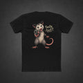 Taste Test Tee — t-shirt printed with a grinning cartoon opossum pointing a pistol next to the words “Taste Test?”