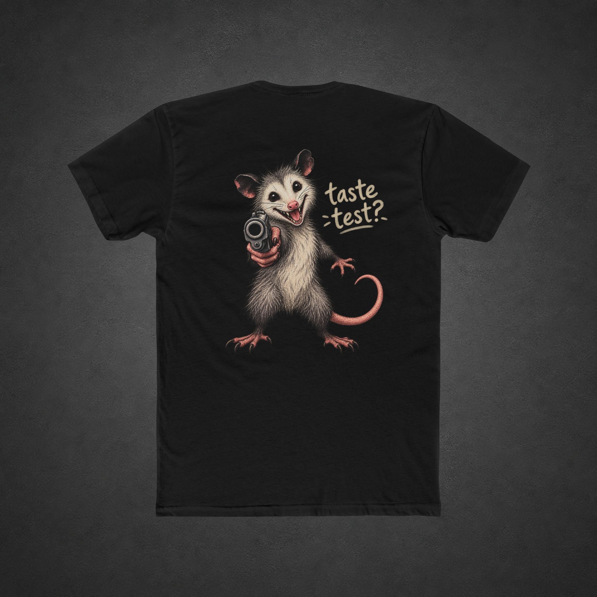 Taste Test Tee — t-shirt printed with a grinning cartoon opossum pointing a pistol next to the words “Taste Test?”